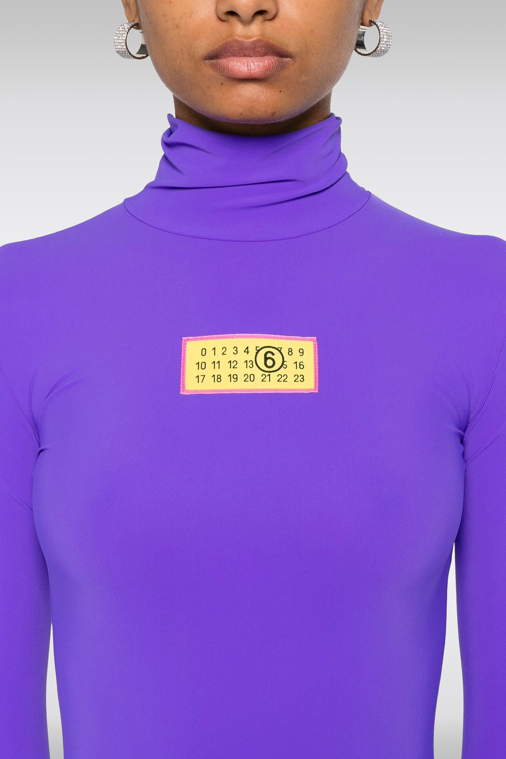 alt-image__Body-in-lycra-viola-con-maniche-lunghe-e-logo-al-petto